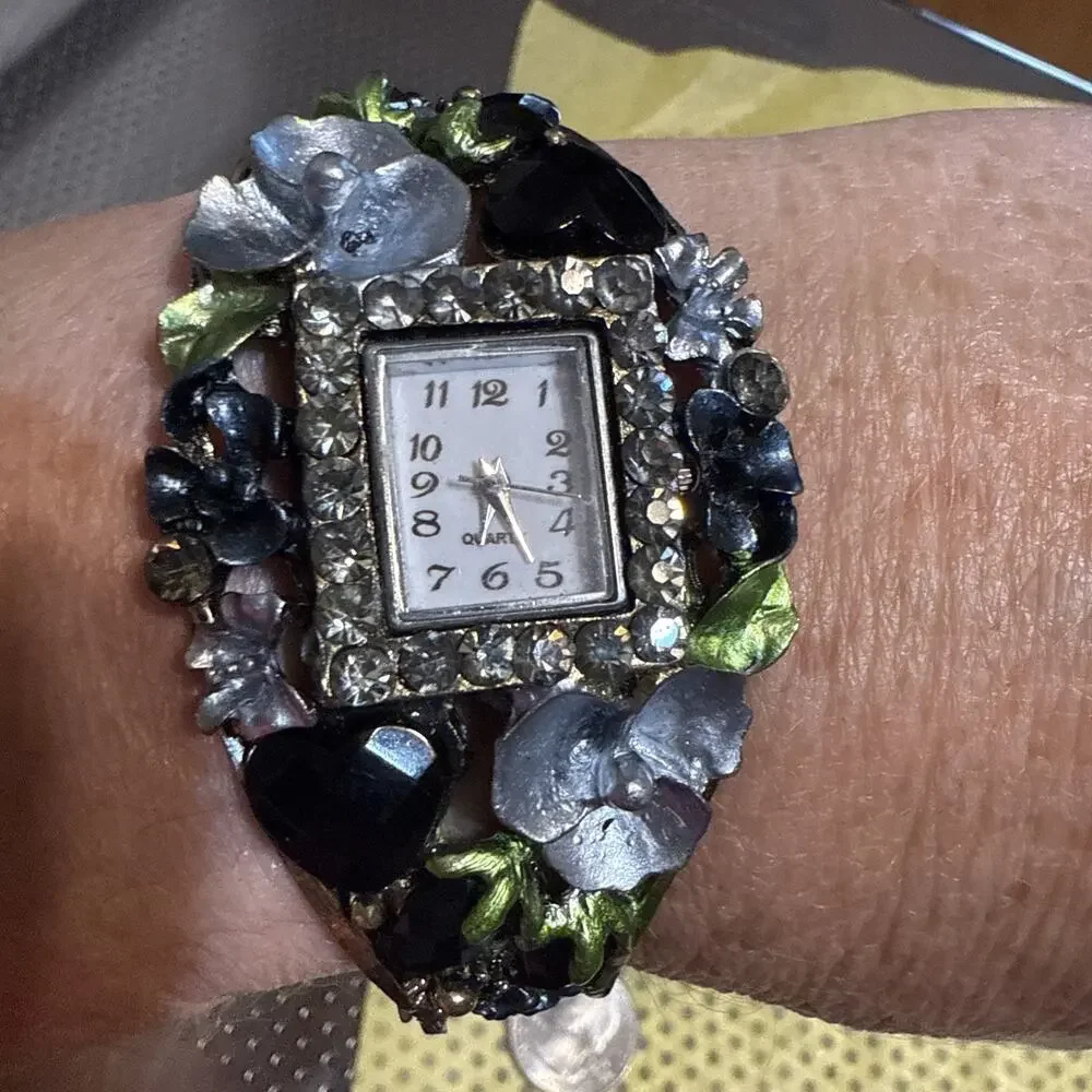 vintage-style floral women's cuff watch with a square face and black and silver-